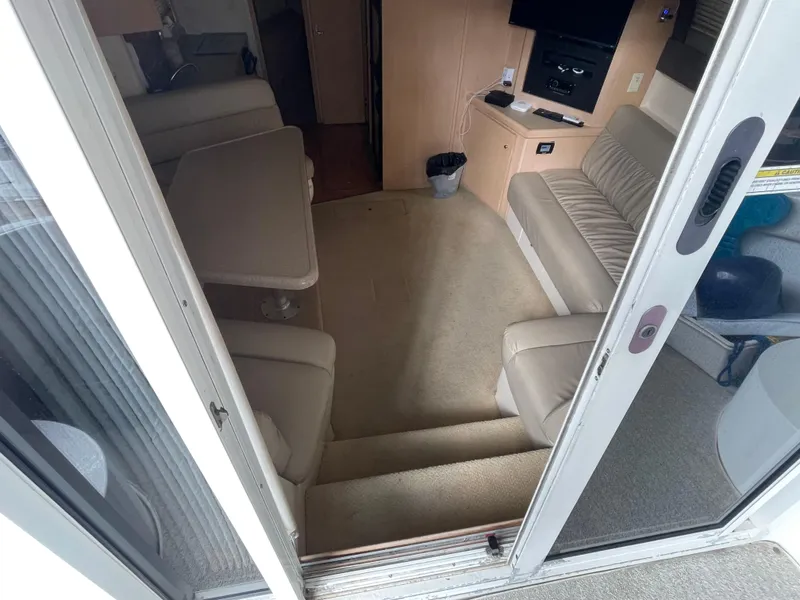 Slide: The Image of Interior of 2002 Carver 350 Mariner yacht with seating and entertainment area. - 19