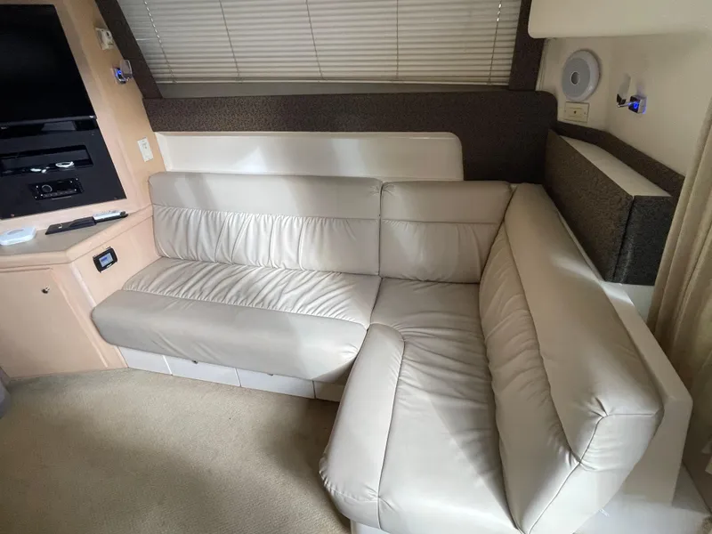 Slide: The Image of Interior of 2002 Carver 350 Mariner with beige leather sofa and entertainment system. - 20