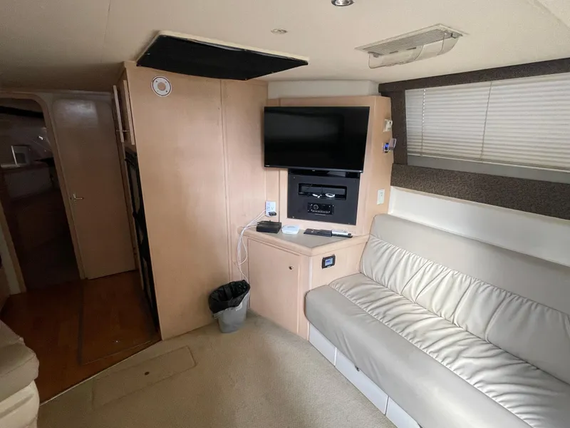 Slide: The Image of Interior of 2002 Carver 350 Mariner yacht with sofa and mounted TV. - 21