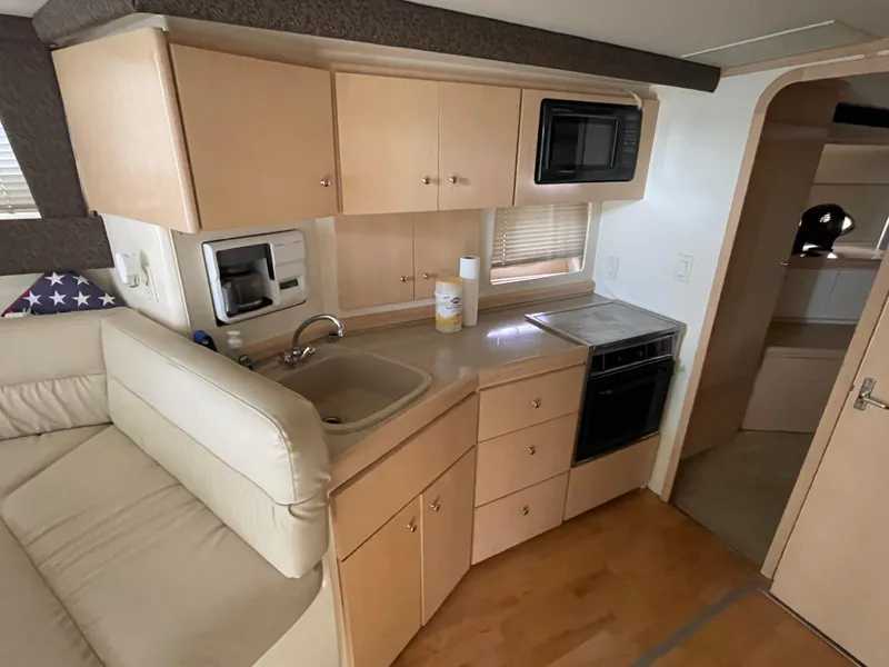 Slide: The Image of Interior of 2002 Carver 350 Mariner yacht with kitchenette and seating area. - 23