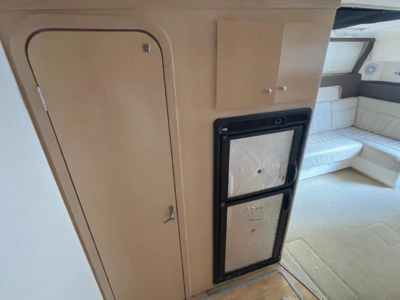 Slide: The Image of Interior of 2002 Carver 350 Mariner yacht with fridge and seating area. - 24