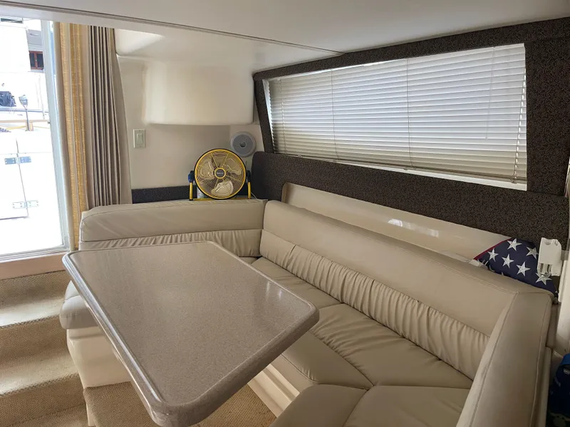 Slide: The Image of Interior of 2002 Carver 350 Mariner yacht with beige seating and table. - 28