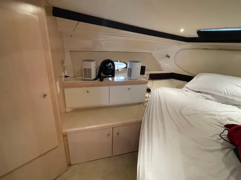 Slide: The Image of Interior cabin of 2002 Carver 350 Mariner with bed and storage cabinets. - 29