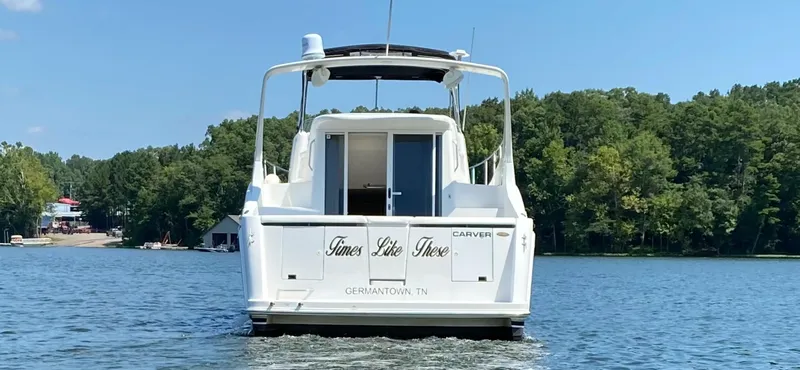 Slide: The Image of 2002 Carver 350 Mariner boat on a lake, surrounded by trees. - 3