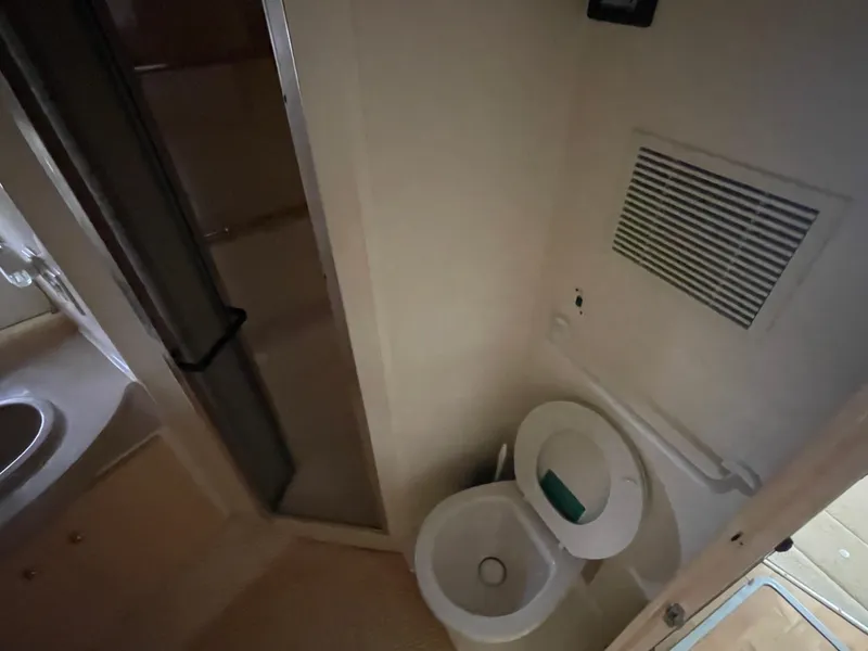Slide: The Image of Bathroom interior of 2002 Carver 350 Mariner yacht, featuring toilet and shower. - 31