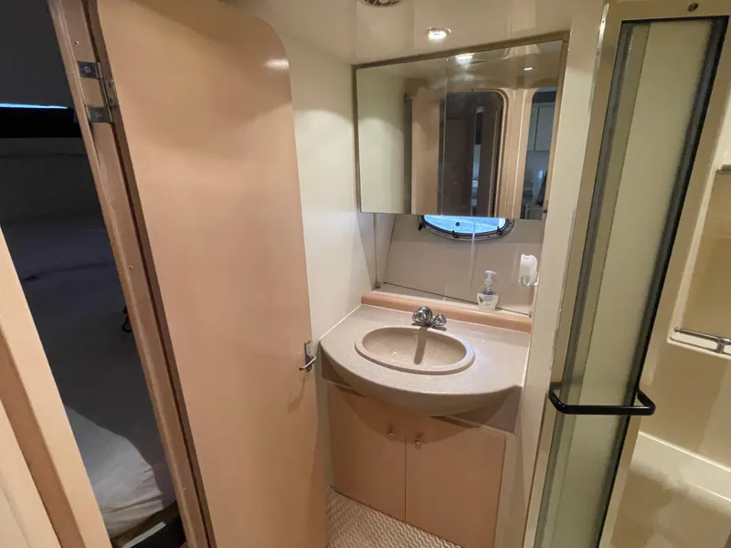 Slide: The Image of 2002 Carver 350 Mariner bathroom with sink, mirror, and shower. - 33
