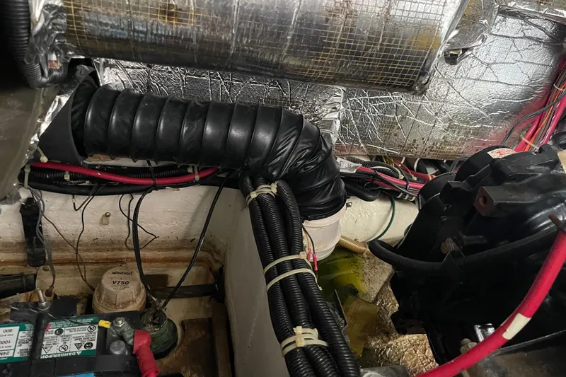 Slide: The Image of Engine compartment of a 2002 Carver 350 Mariner with wiring and ventilation ducts. - 44