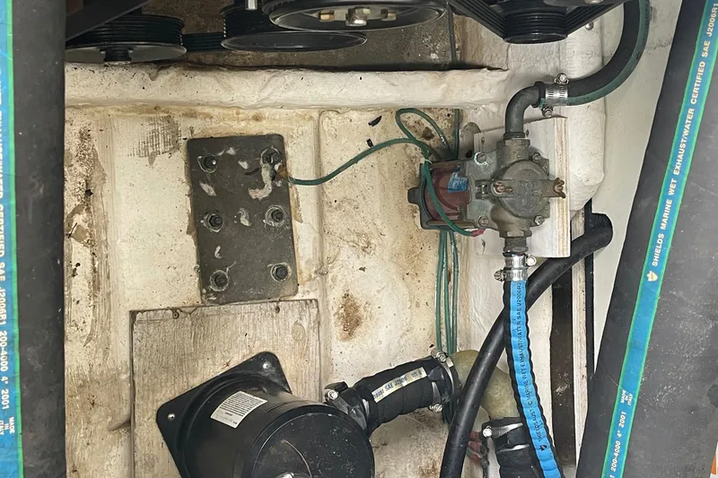 Slide: The Image of Engine compartment of a 2002 Carver 350 Mariner with visible hoses and components. - 46