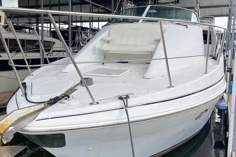 Slide: The Image of 2002 Carver 350 Mariner yacht docked in a marina, showcasing sleek design and spacious deck. - 5