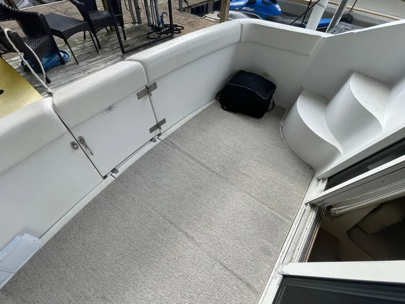 Slide: The Image of 2002 Carver 350 Mariner boat deck with carpet and storage compartments. - 6