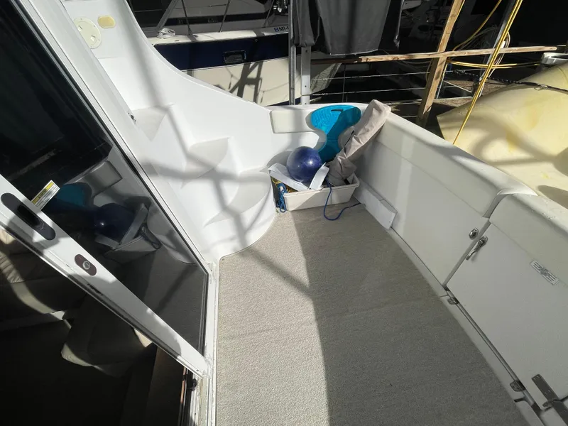 Slide: The Image of 2002 Carver 350 Mariner deck area with seating and storage. - 7