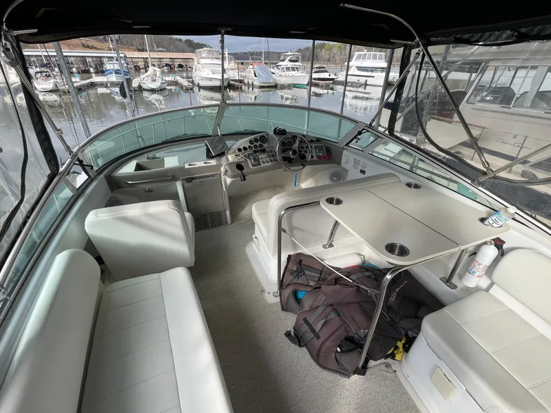 Slide: The Image of 2002 Carver 350 Mariner interior with seating and helm, docked at marina. - 9