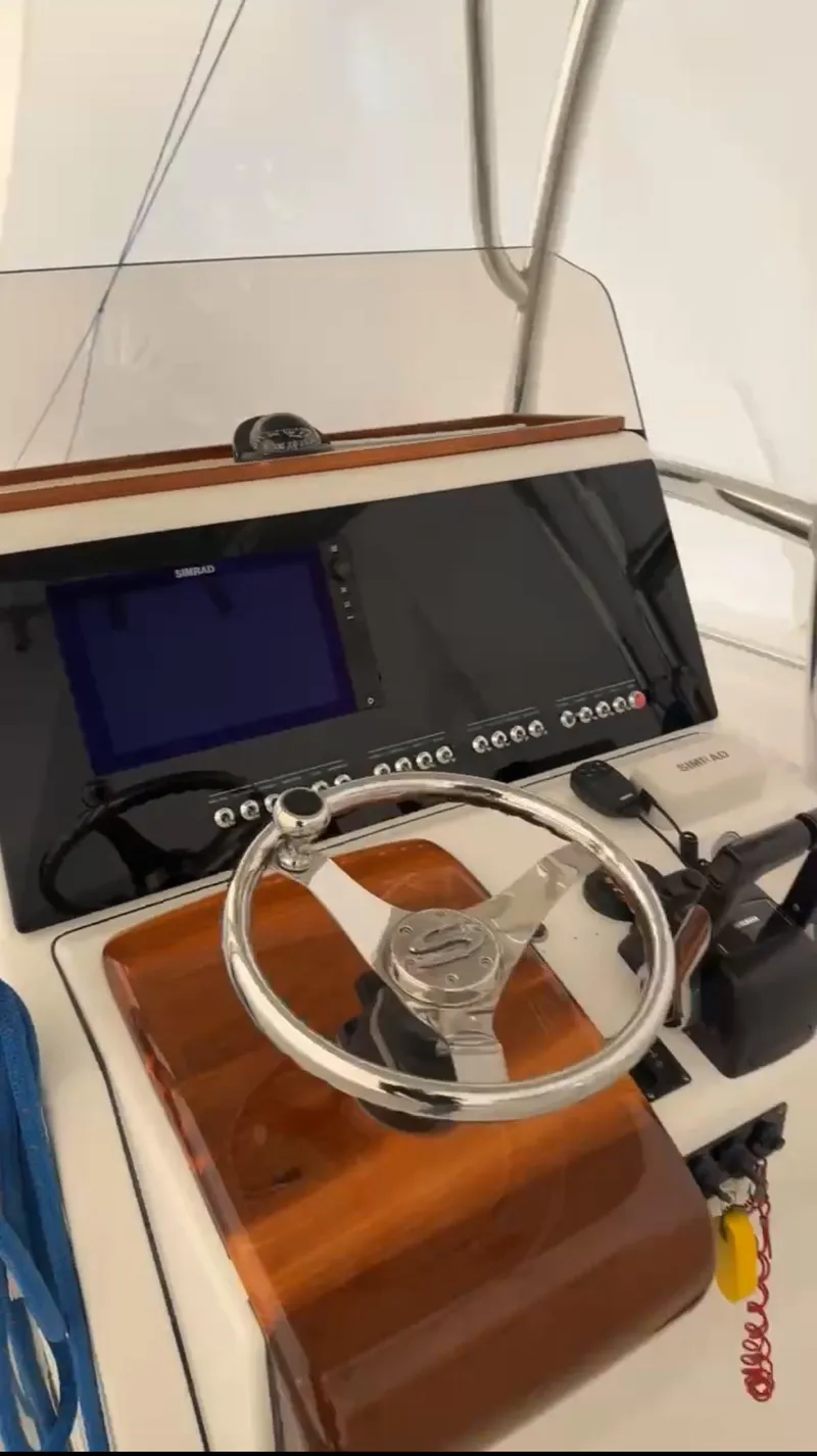 Slide: The Image of 2015 Sportsman Heritage 251 Center Console helm with steering wheel and navigation display. - 2