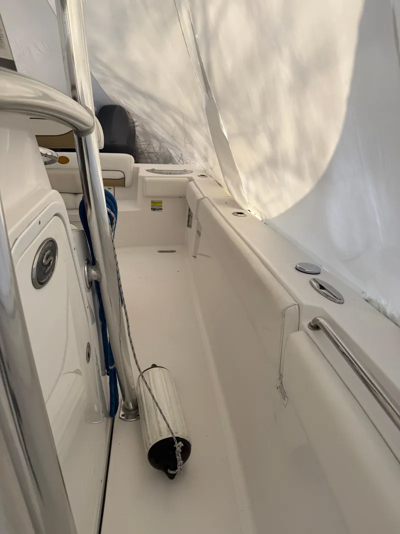 Slide: The Image of 2015 Sportsman Heritage 251 Center Console boat interior with white seating and railing. - 5