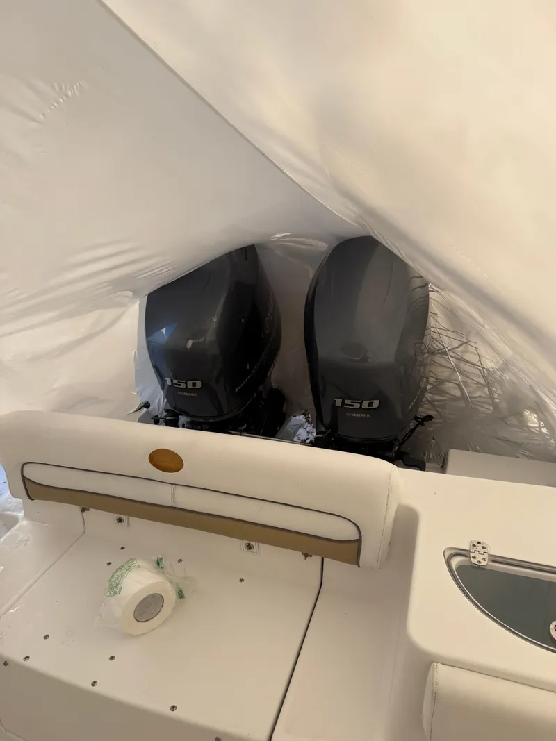 Slide: The Image of 2015 Sportsman Heritage 251 Center Console with twin 150 horsepower engines, covered and stored. - 7