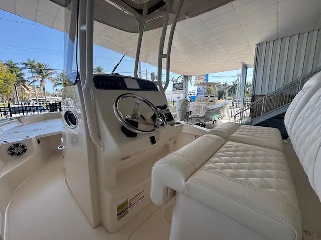 Slide: The Image of 2025 Grady-White 231 Coastal Explorer boat interior with steering wheel and seating. - 10