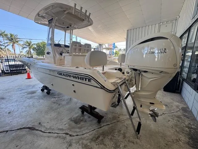 Slide: The Image of 2025 Grady-White 231 Coastal Explorer boat with Yamaha engine, displayed indoors. - 12