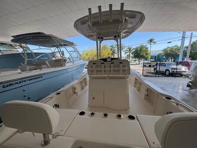Slide: The Image of 2025 Grady-White 231 Coastal Explorer boat interior, showcasing seating and helm station. - 14