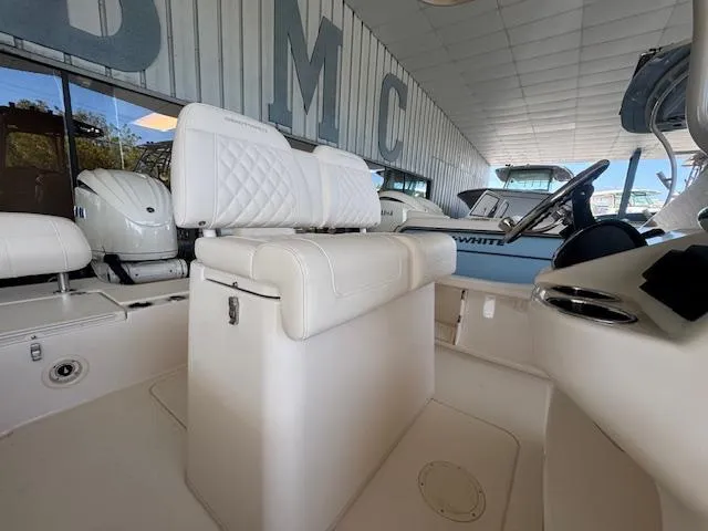 Slide: The Image of 2025 Grady-White 231 Coastal Explorer boat interior with white seating and helm. - 17