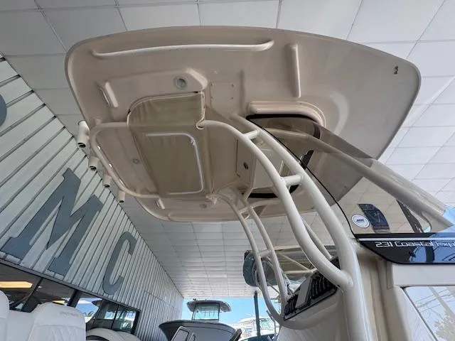 Slide: The Image of 2025 Grady-White 231 Coastal Explorer boat, view of the T-top and console details. - 18