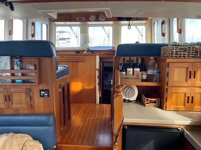 Slide: The Image of Interior of 2005 Nordic Tug 37 with wooden cabinetry and seating. - 11