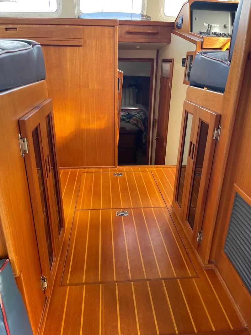 Slide: The Image of Interior of a 2005 Nordic Tug 37, featuring wooden cabinetry and flooring. - 15
