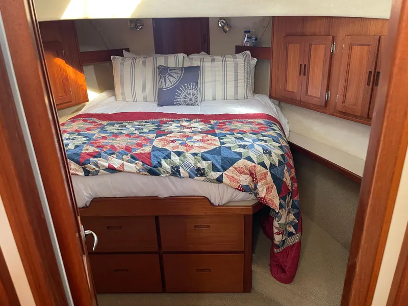 Slide: The Image of Cozy cabin interior of 2005 Nordic Tug 37 with colorful quilt and wooden cabinetry. - 18