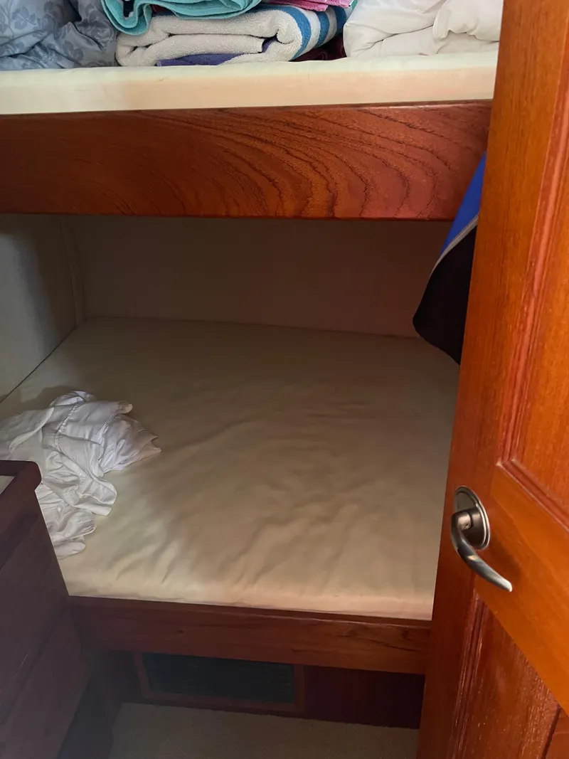 Slide: The Image of Nordic Tug 37 (2005) cabin with wooden bunk beds and folded linens. - 20