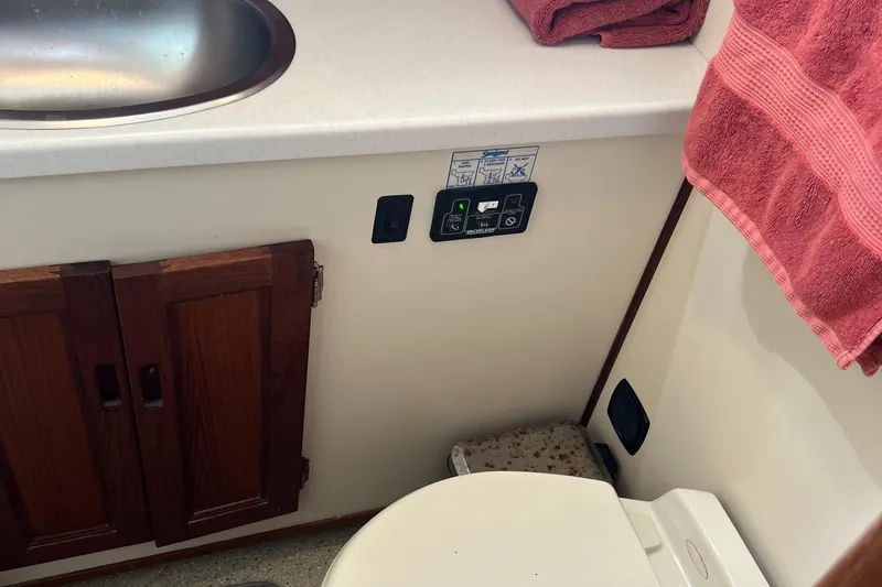 Slide: The Image of 2005 Nordic Tug 37 bathroom with sink, toilet, and control panel. - 22