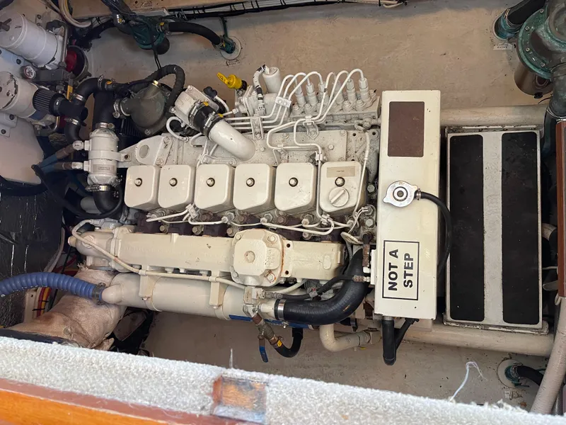 Slide: The Image of Engine compartment of a 2005 Nordic Tug 37 boat, featuring a detailed view of the engine. - 26