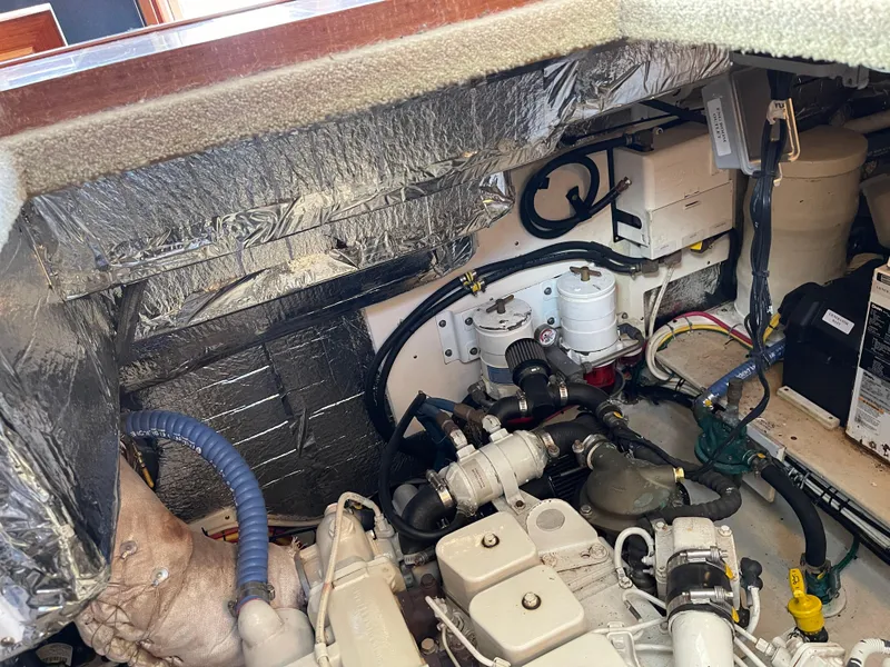 Slide: The Image of Engine room of a 2005 Nordic Tug 37, showcasing mechanical components and insulation. - 27