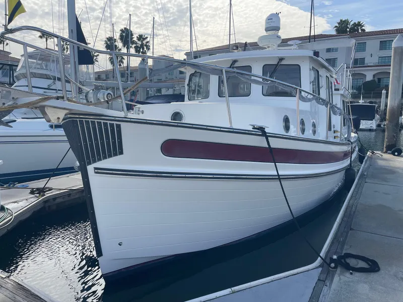 Slide: The Image of 2005 Nordic Tug 37 docked at marina, showcasing classic design and sturdy build. - 4