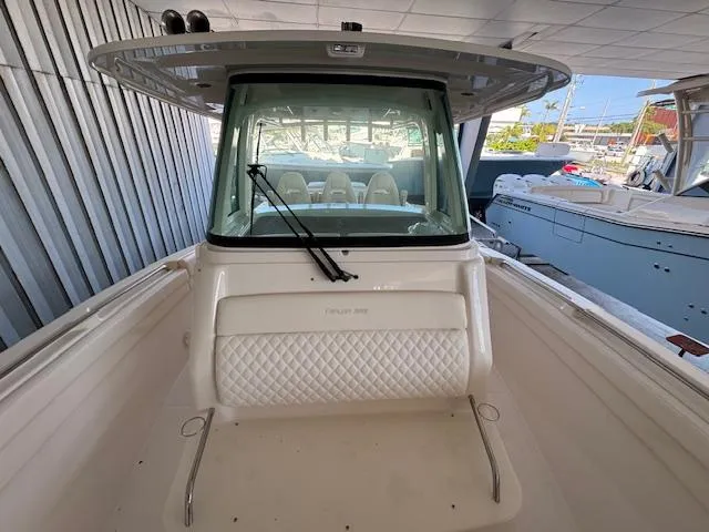 Slide: The Image of 2025 Grady-White Canyon 326 boat, front view, docked in a marina. - 19
