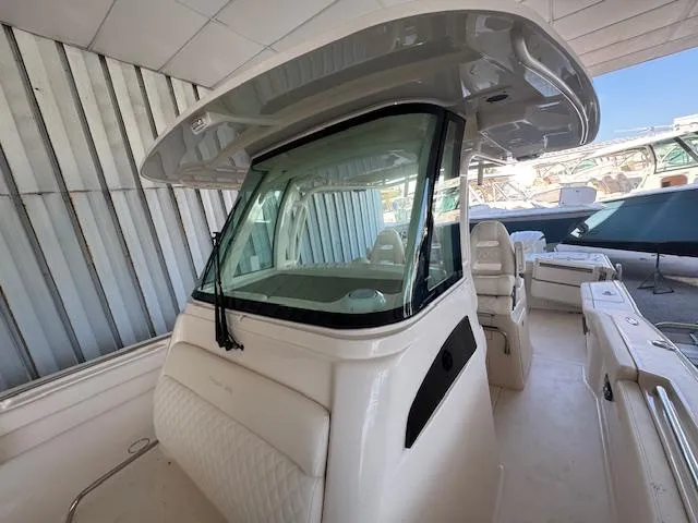 Slide: The Image of 2025 Grady-White Canyon 326 boat interior with helm and seating area. - 20