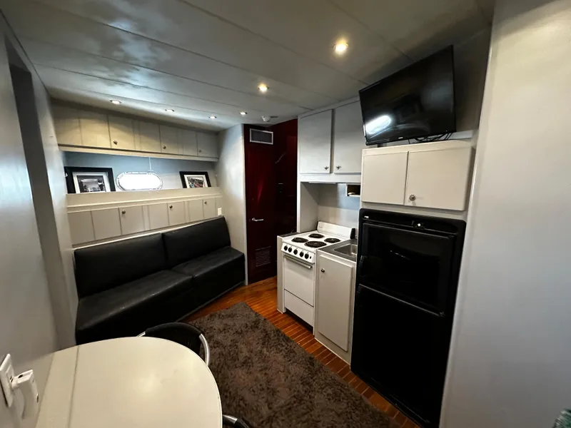 Slide: The Image of Interior of 1996 Monte Fino 92 MY yacht with kitchen, sofa, and TV. - 39