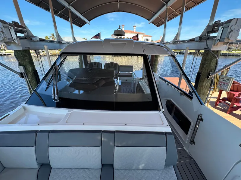 Slide: The Image of 2022 Galeon 325 GTO yacht docked, showcasing sleek design and spacious seating area. - 25