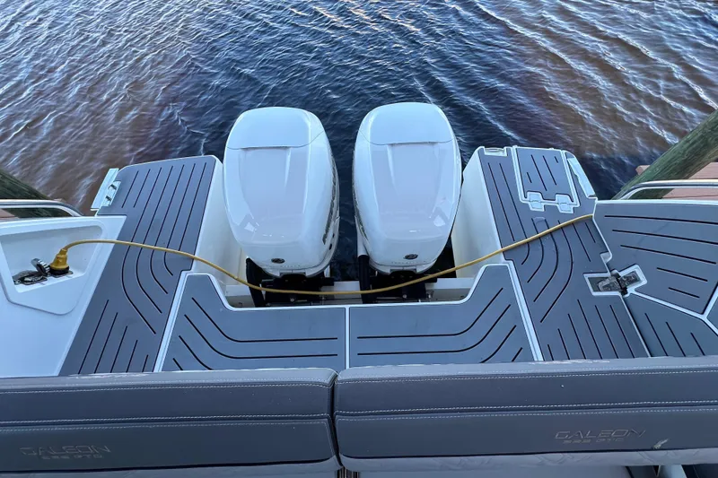 Slide: The Image of 2022 Galeon 325 GTO boat with dual outboard engines on water. - 30