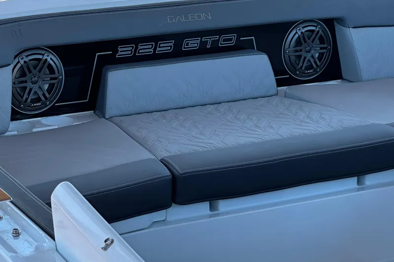 Slide: The Image of 2022 Galeon 325 GTO boat interior with cushioned seating and speakers. - 31