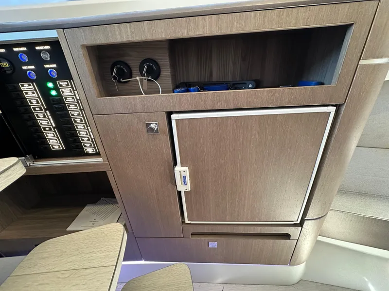 Slide: The Image of 2022 Galeon 325 GTO interior with control panel and storage cabinet. - 36