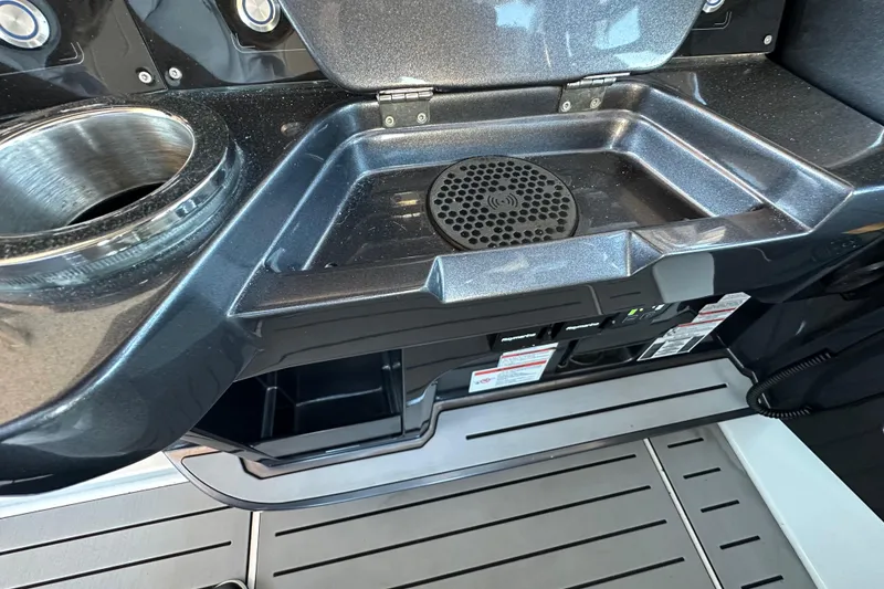Slide: The Image of 2022 Galeon 325 GTO boat interior with cup holder and storage compartment. - 46