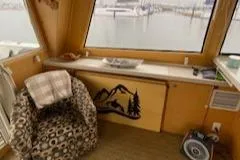 Slide: The Image of Cozy interior of a 1995 Navigator 50 yacht with patterned chair and scenic window view. - 11