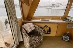 Slide: The Image of Cozy interior of 1995 Navigator 50 yacht with patterned chair and scenic window view. - 13