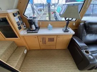 Slide: The Image of Interior of a 1995 Navigator 50 yacht with a cozy seating area and coffee station. - 15