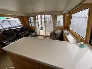 Slide: The Image of Interior of 1995 Navigator 50 yacht with spacious seating and large windows. - 16