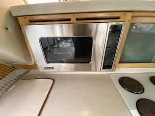 Slide: The Image of 1995 Navigator 50 kitchen with stainless steel microwave and electric stove. - 20