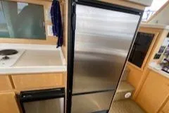 Slide: The Image of Compact kitchen area in a 1995 Navigator 50 yacht with stainless steel appliances. - 22