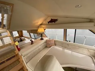 Slide: The Image of Interior of a 1995 Navigator 50 yacht with cozy seating and a lamp. - 26