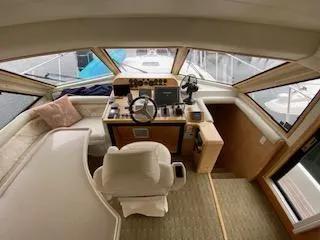 Slide: The Image of Interior view of a 1995 Navigator 50 yacht cockpit with steering wheel and seating. - 28