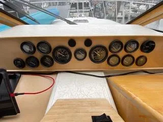 Slide: The Image of Control panel of a 1995 Navigator 50 boat with multiple gauges and dials. - 29