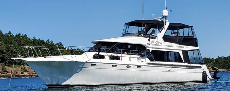 Slide: The Image of Navigator 50 yacht from 1995 on calm water with forested shoreline. - 4